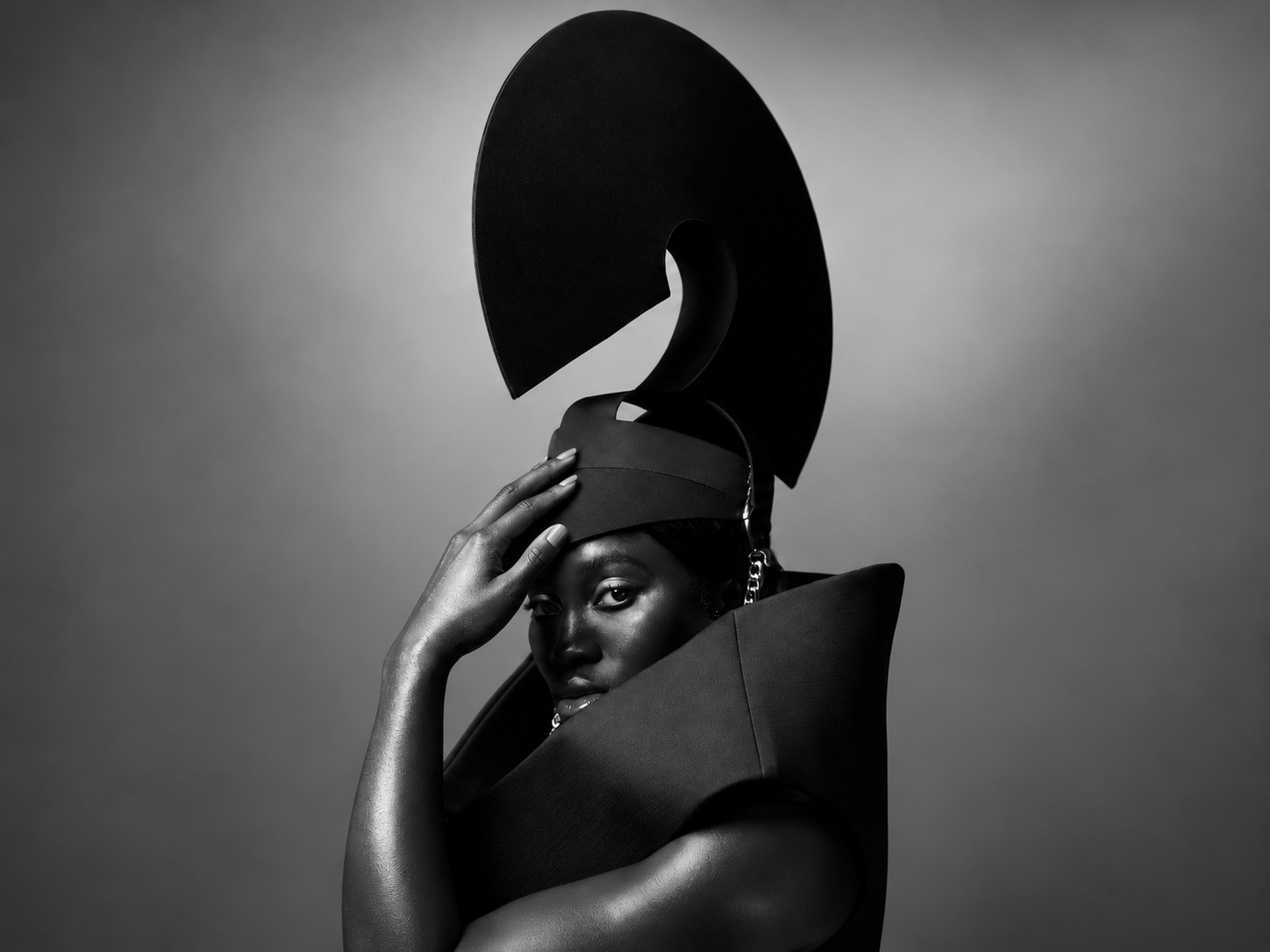Monochrome editorial portrait with sculptural fashion construction
